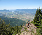 Sitting at the rocky viewpoint on Elk Mountain, having lunch and looking out towards the Fraser Valley