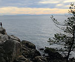 People on the rocks soaking in the views at Lighthouse Park in West Vancouver